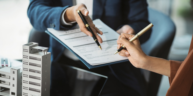Considering buying a home, investing in real estate. Broker sign Considering buying a home, investing in real estate. Broker signs a sales agreement. agent, lease agreement, successful deal.